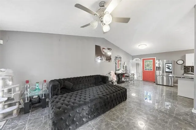 a kitchen that has a lot of cabinets a sink and appliances