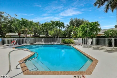 a view of a swimming pool with a lounge chair