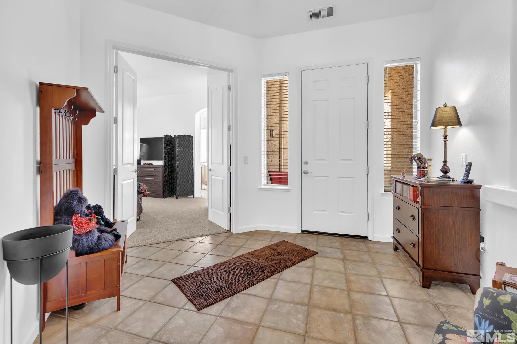 9900 Wilbur May, Unit 3902 Reno, NV 89521 - Photo 15 of 28 a living room with a couch and a table