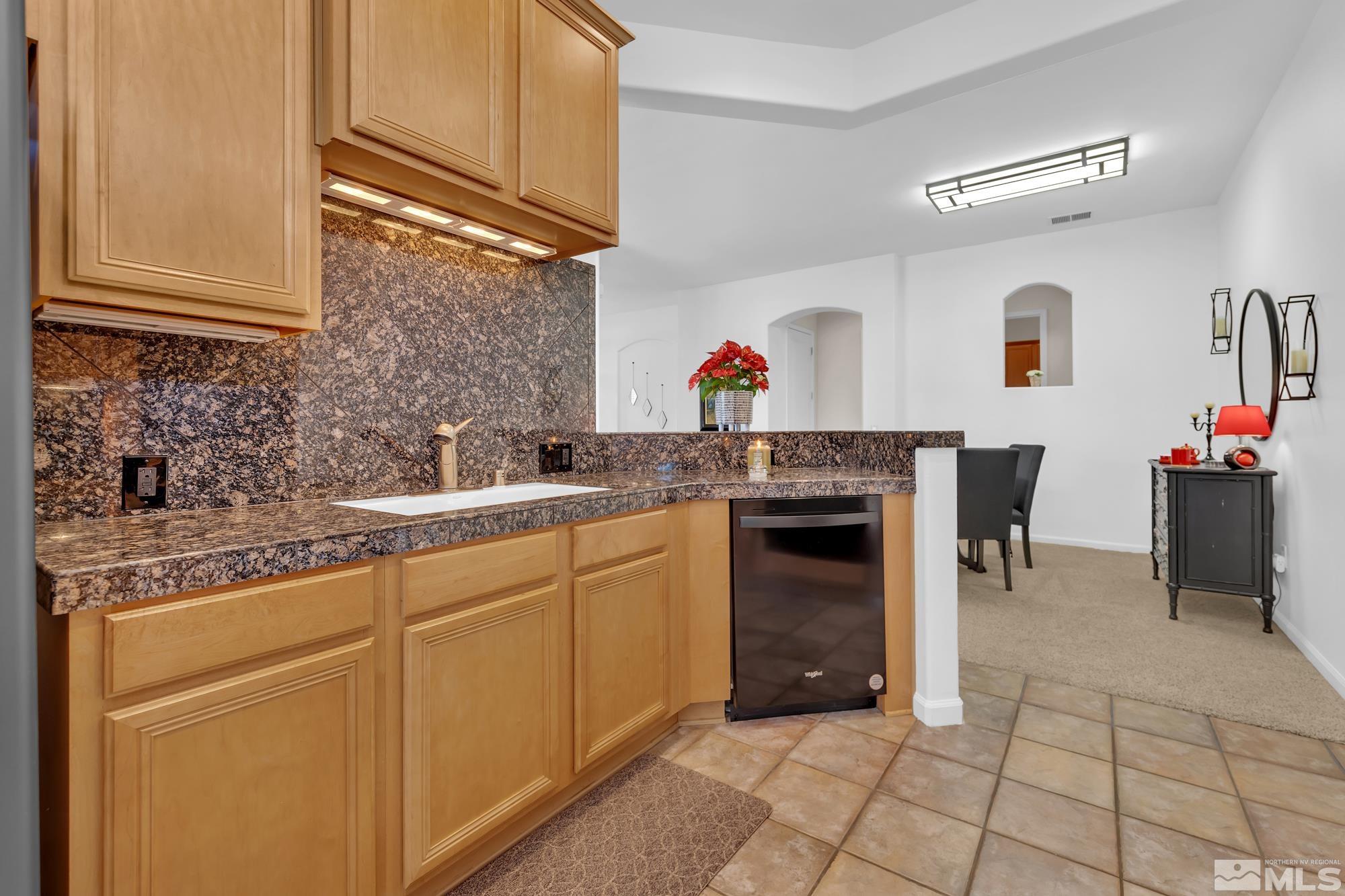 9900 Wilbur May, Unit 3902 Reno, NV 89521 - Photo 17 of 28 a kitchen with stainless steel appliances granite countertop a stove cabinets and a sink