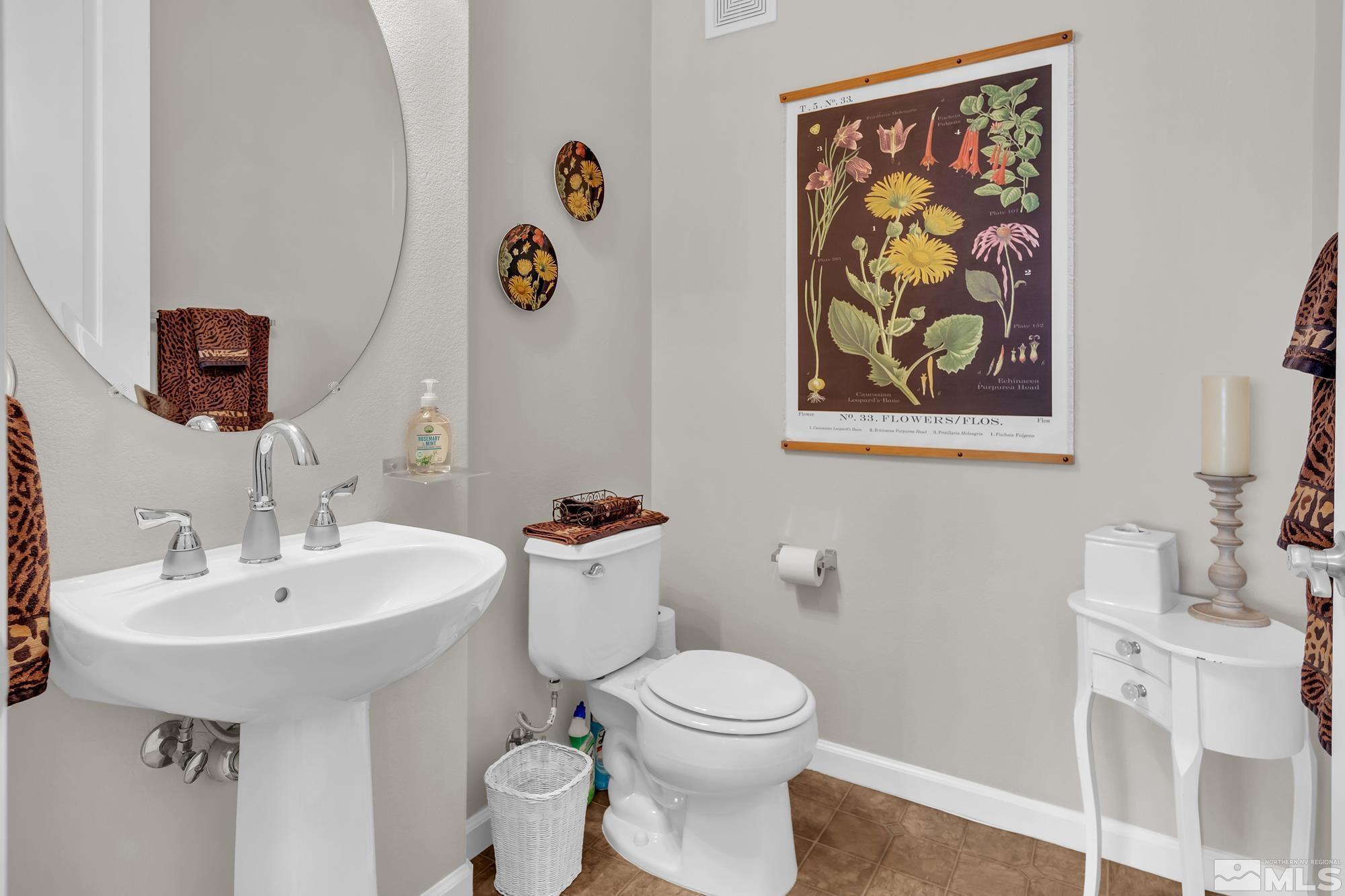 9900 Wilbur May, Unit 3902 Reno, NV 89521 - Photo 23 of 28 a bathroom with a toilet a sink and mirror