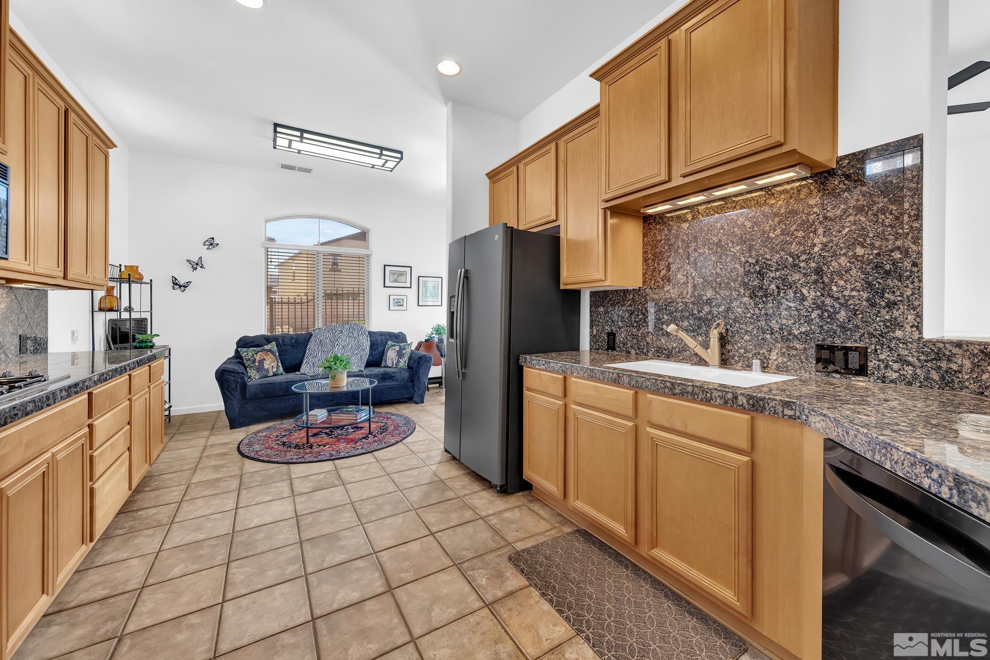 9900 Wilbur May, Unit 3902 Reno, NV 89521 - Photo 5 of 28 a kitchen with stainless steel appliances granite countertop a sink stove and cabinets