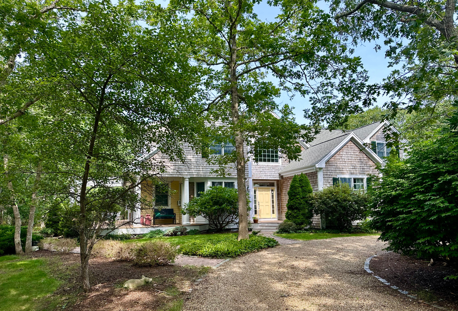 248 Pond Road West Tisbury, MA 02568 - Photo 5 of 34 a front view of a house with a yard and porch