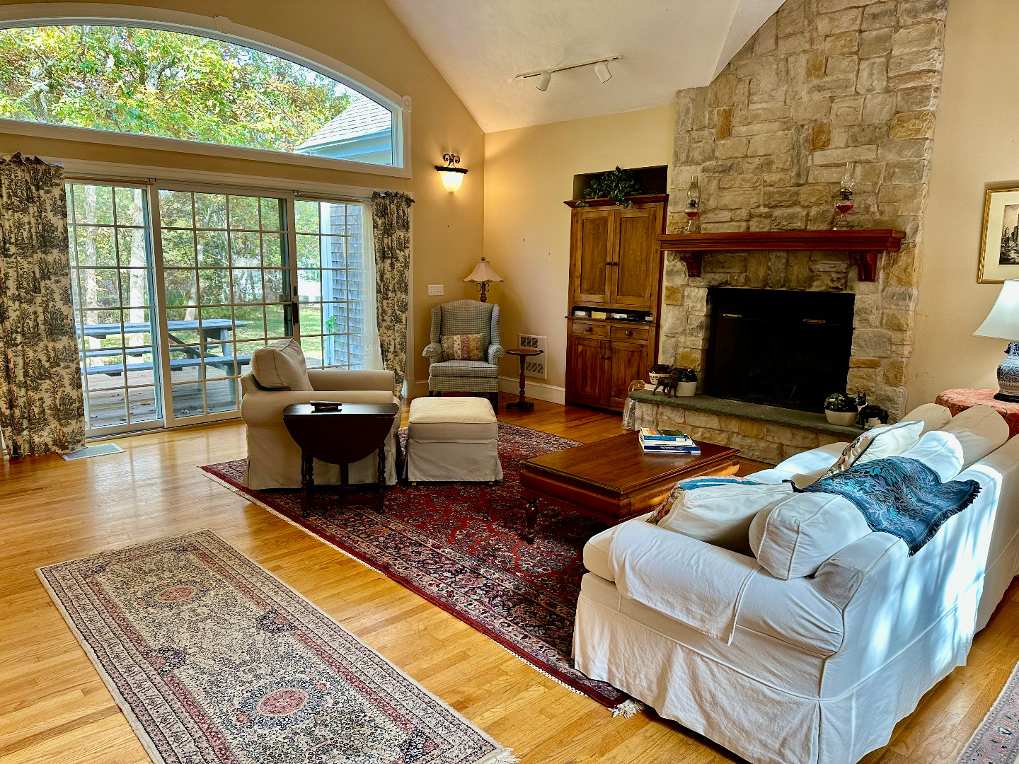248 Pond Road West Tisbury, MA 02568 - Photo 6 of 34 a living room with furniture a fireplace and a floor to ceiling window