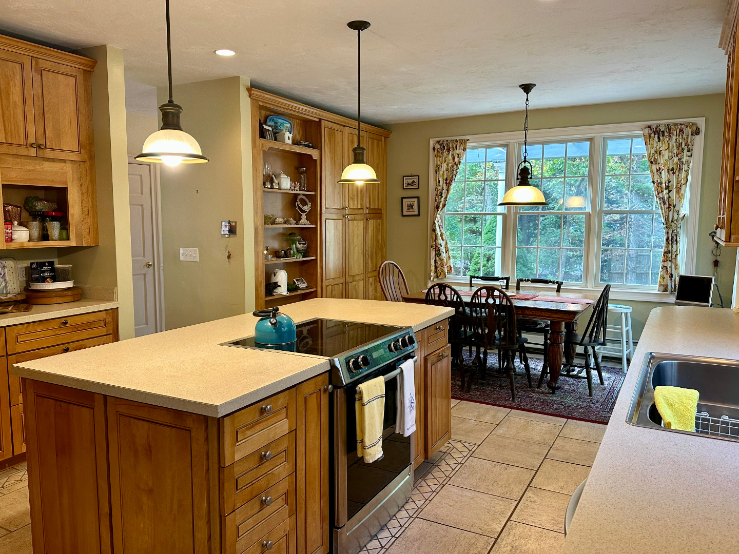 248 Pond Road West Tisbury, MA 02568 - Photo 8 of 34 a kitchen with stainless steel appliances granite countertop a stove a refrigerator a dining table and chairs with the view of living room