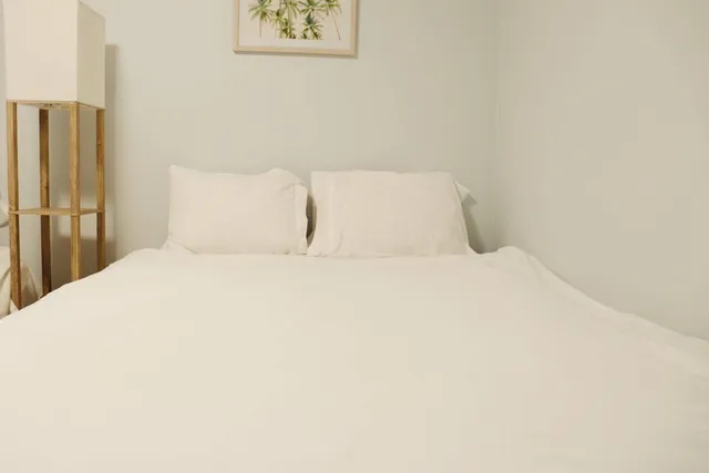 a large bed with a white comforter