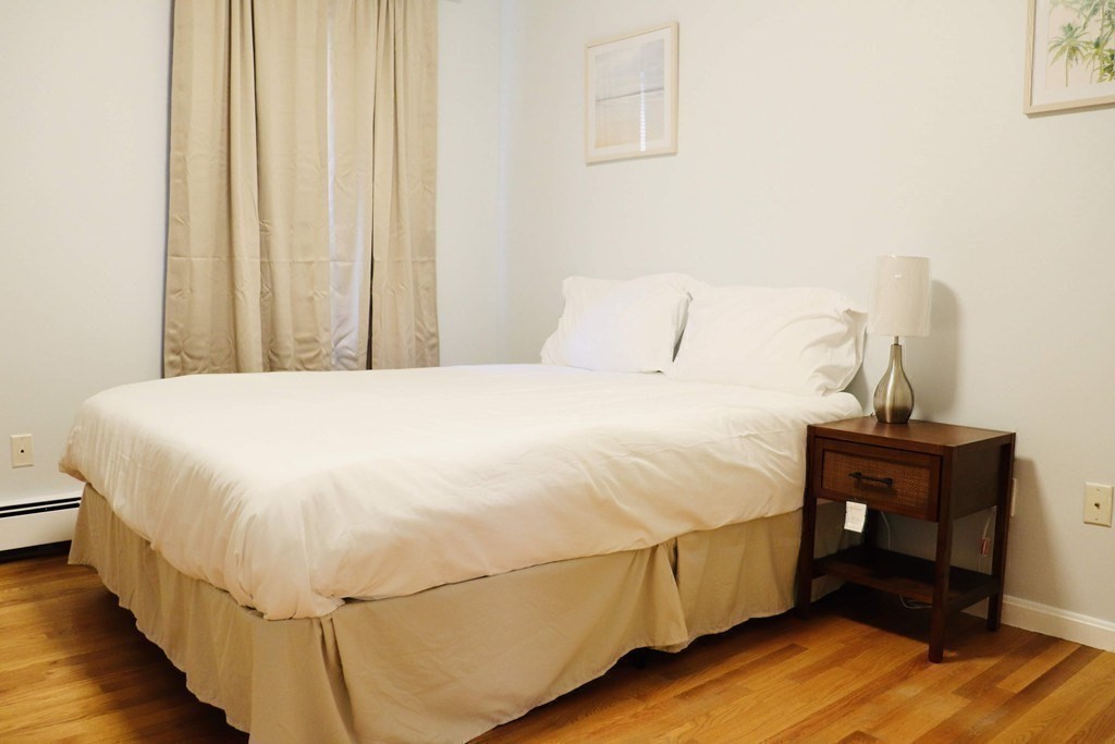 12 Regent Street, Unit 2F Cambridge, MA 02140 - Photo 17 of 29 a bedroom with a bed and a table