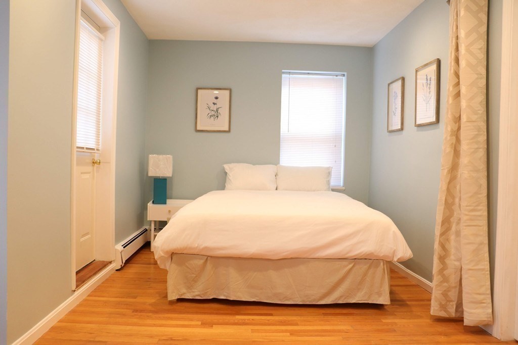 12 Regent Street, Unit 2F Cambridge, MA 02140 - Photo 27 of 29 a bedroom with a bed and wooden floor