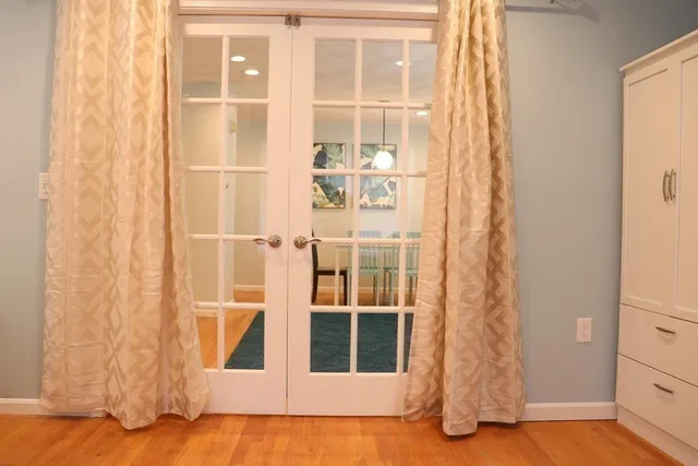 a bedroom with a bed and a mirror