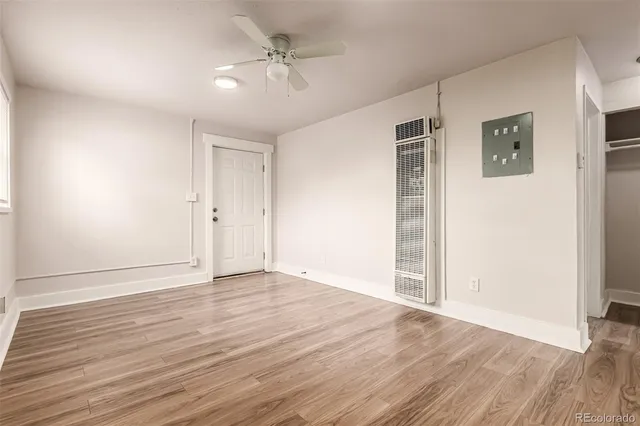 a view of an empty room with wooden floor