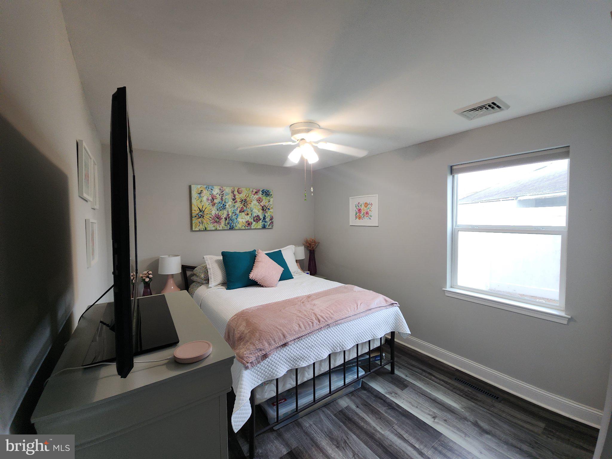 802 Devon Road Riverside, NJ 08075 - Photo 16 of 29 a bedroom with a bed and a flat screen tv