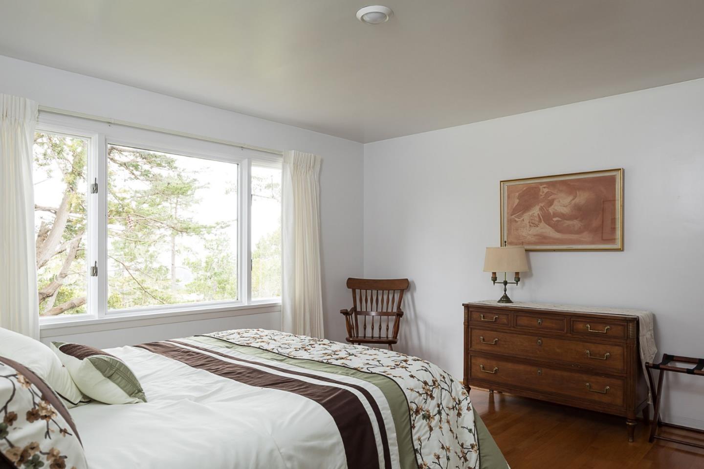 1508 Viscaino Road Pebble Beach, CA 93953 - Photo 19 of 23 a bedroom with a bed and a window