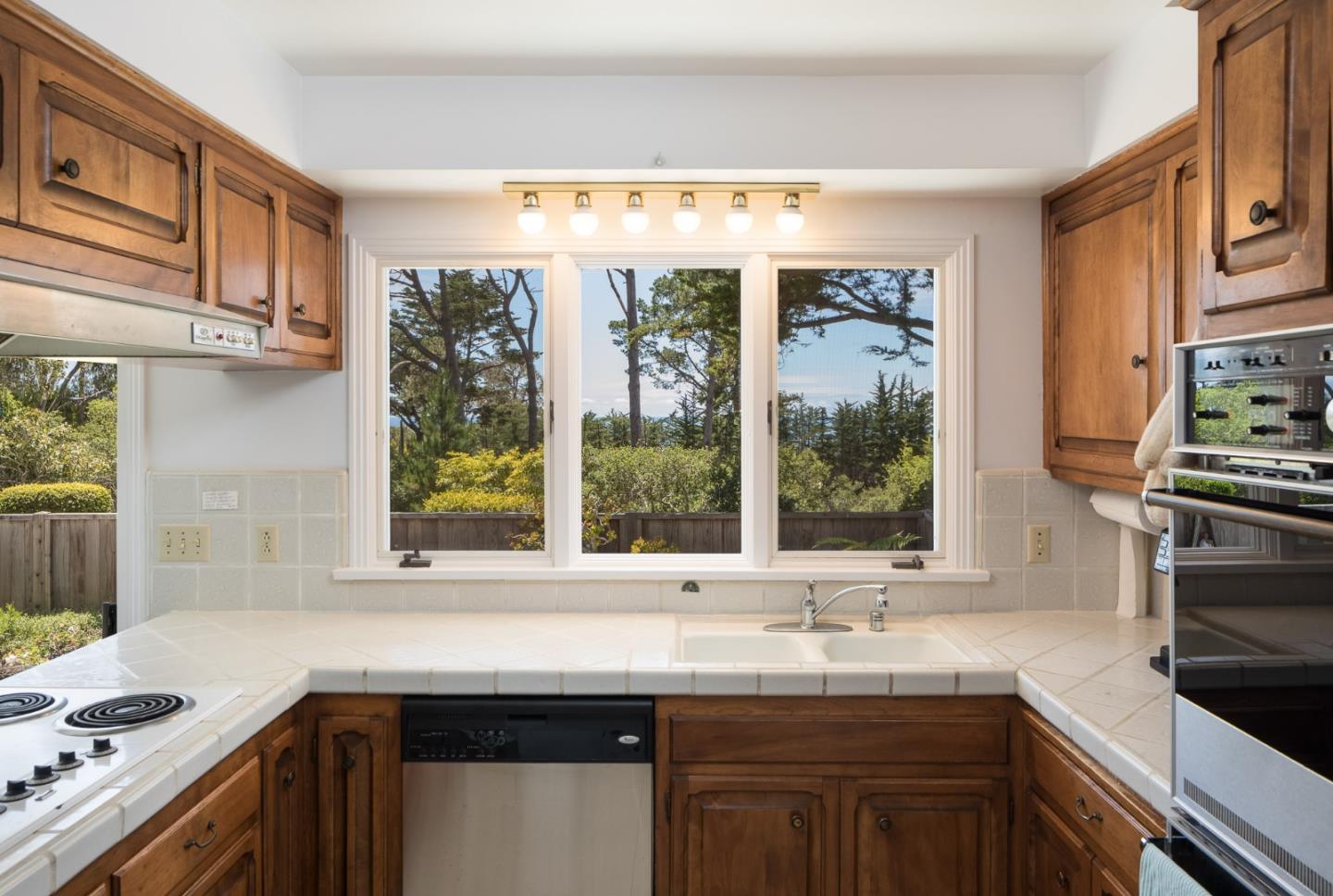 1508 Viscaino Road Pebble Beach, CA 93953 - Photo 3 of 23 a kitchen with granite countertop a sink and a window