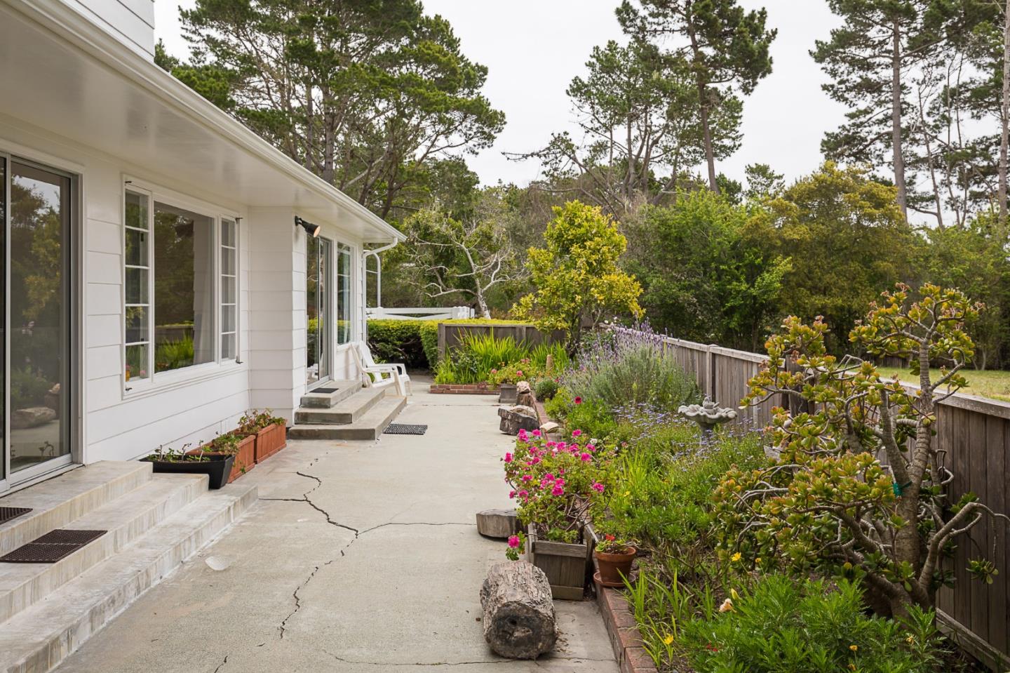 1508 Viscaino Road Pebble Beach, CA 93953 - Photo 7 of 23 a view of a chair and table in backyard of the house