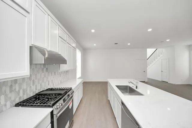 a kitchen that has a sink and a stove