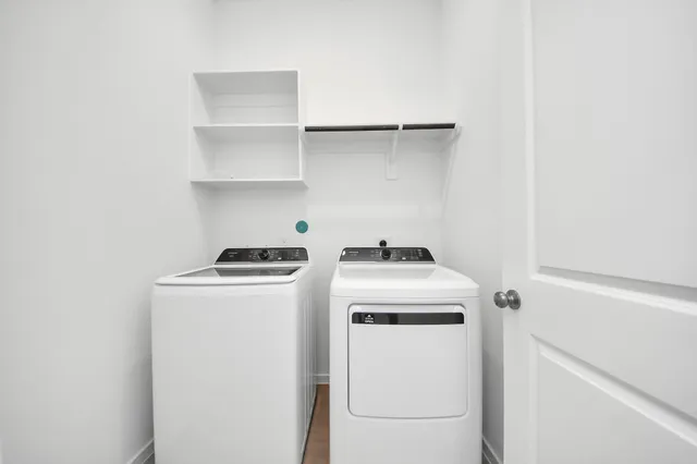 a view of storage and utility room with washer and dryer