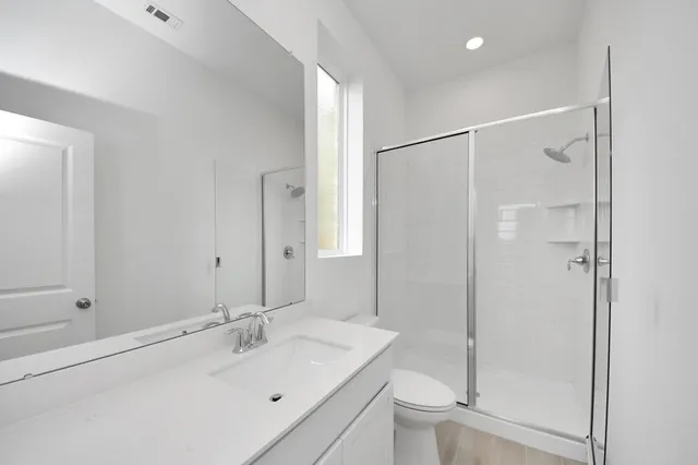 a bathroom with a sink toilet and shower