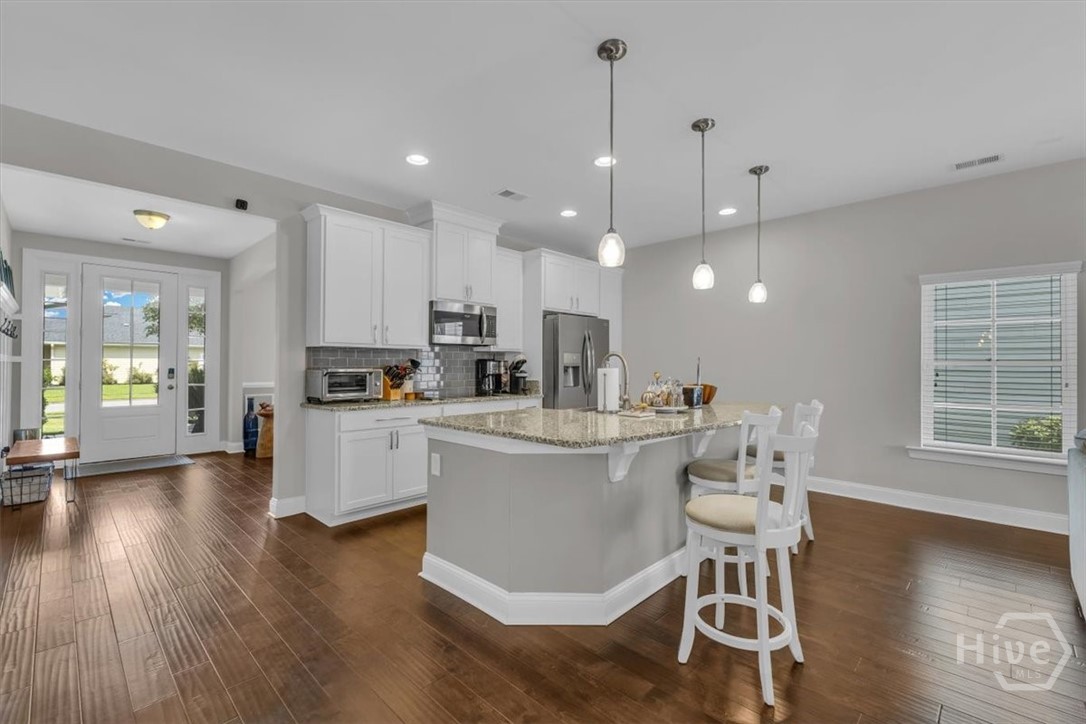 291 McQueen Drive Pooler, GA 31322 - Photo 14 of 57 A CHEF'S DREAM KITCHEN WITH AN LARGE ISLAND AND PENDANT LIGHTING