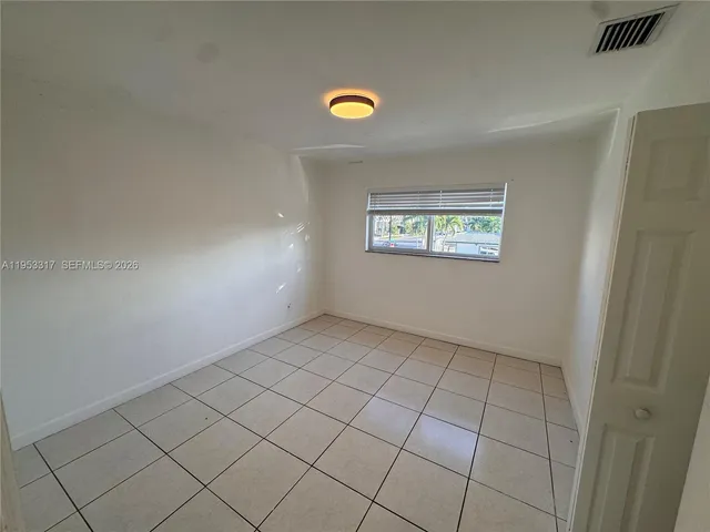 a view of an empty room and window