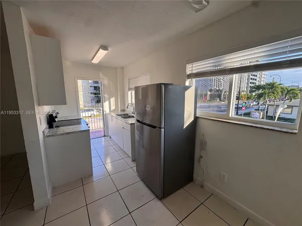 a kitchen with a refrigerator and a stove