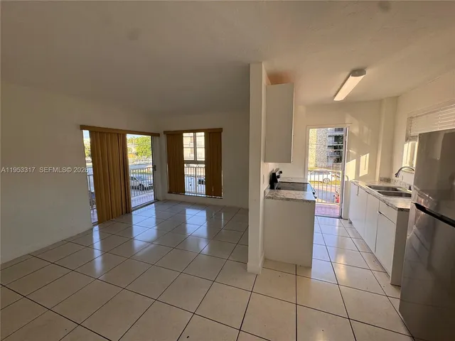 a kitchen with a sink a counter top space and appliances