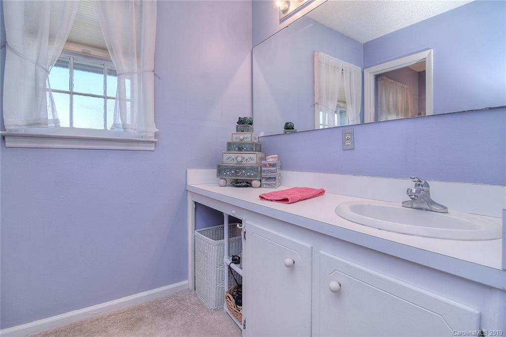6045 Windjammer Drive Tega Cay, SC 29708 - Photo 18 of 31 a bathroom with a sink and a mirror