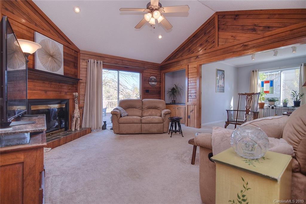 6045 Windjammer Drive Tega Cay, SC 29708 - Photo 3 of 31 a living room with furniture and a fireplace