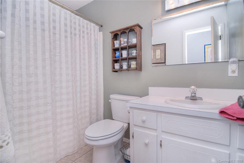 6045 Windjammer Drive Tega Cay, SC 29708 - Photo 23 of 31 a bathroom with a sink vanity mirror and toilet
