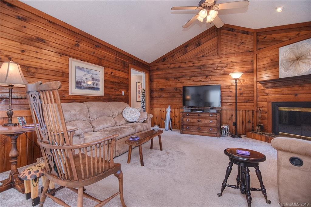 6045 Windjammer Drive Tega Cay, SC 29708 - Photo 4 of 31 a living room with furniture a flat screen tv and a fireplace