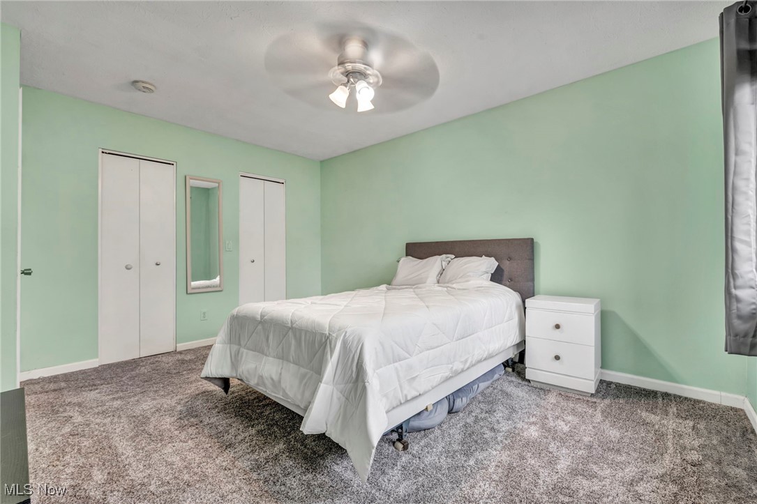 9956 Johnnycake Ridge Road, Unit B5 Painesville, OH 44077 - Photo 18 of 24 Carpeted bedroom with ceiling fan and multiple closets