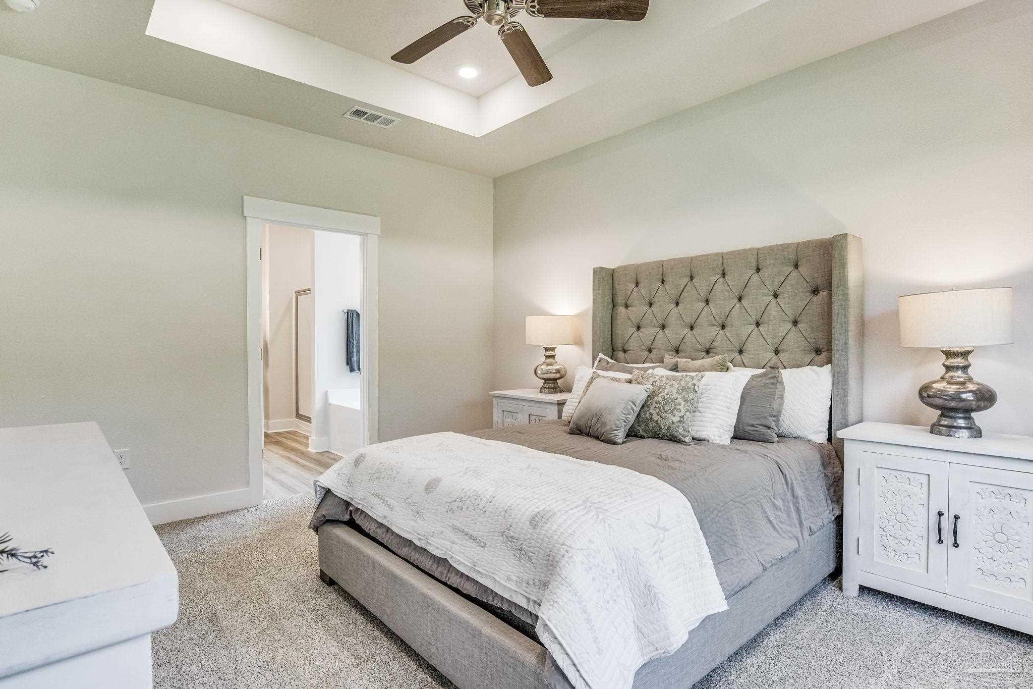 2490 Old Chemstrand Road Cantonment, FL 32533 - Photo 14 of 25 a bedroom with a bed and a lamp on the dresser