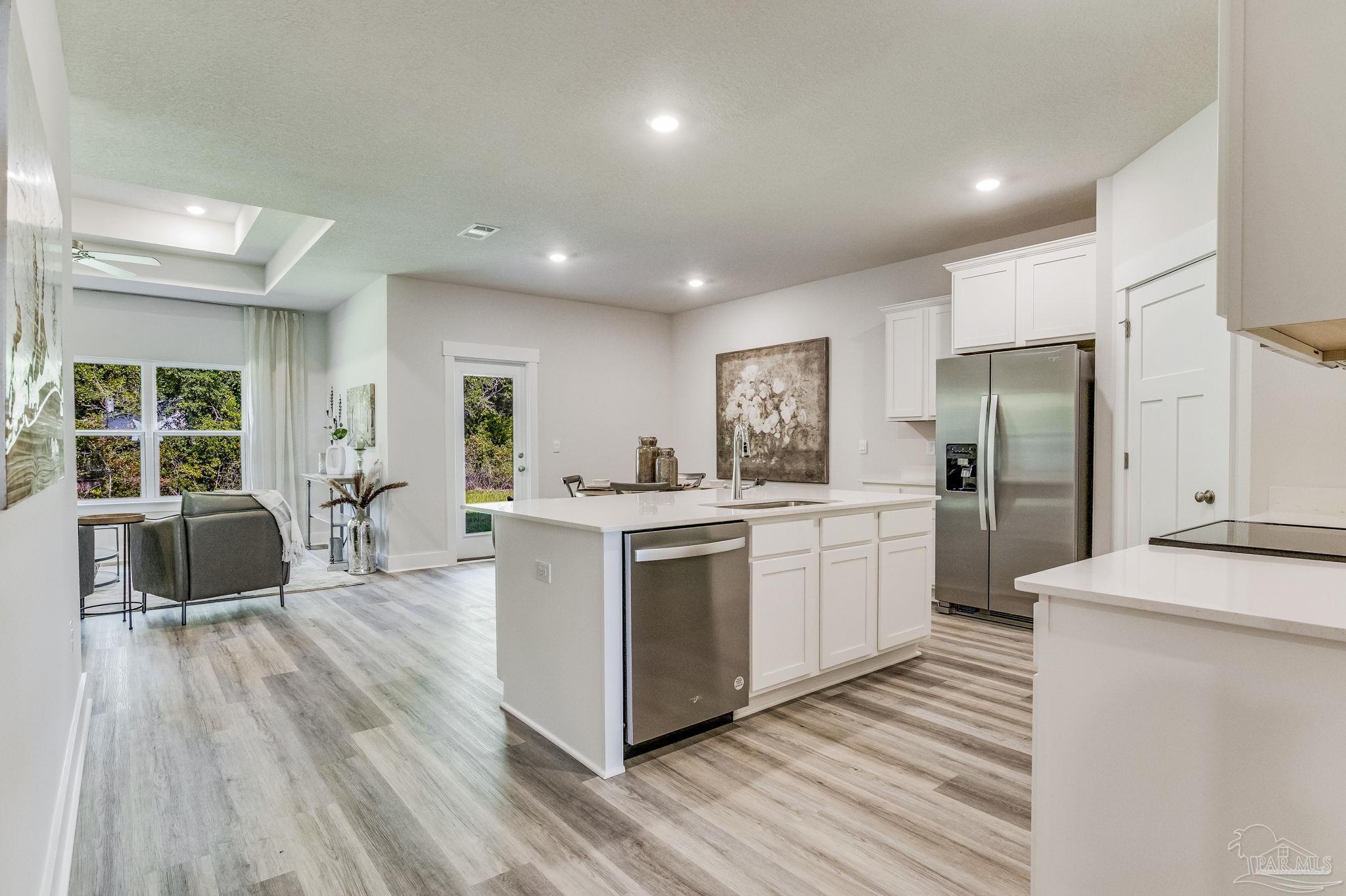 2490 Old Chemstrand Road Cantonment, FL 32533 - Photo 4 of 25 a kitchen with white cabinets and stainless steel appliances
