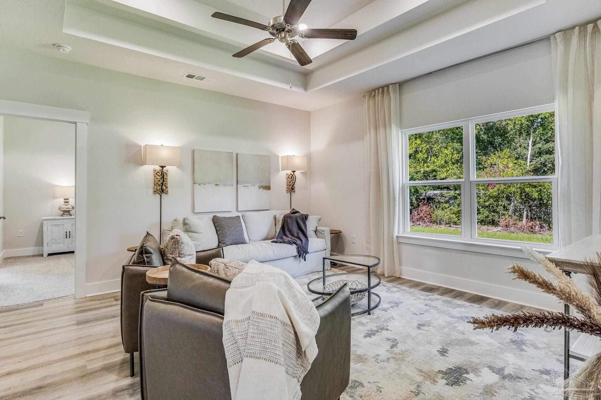 2490 Old Chemstrand Road Cantonment, FL 32533 - Photo 8 of 25 a living room with furniture a window and a chandelier