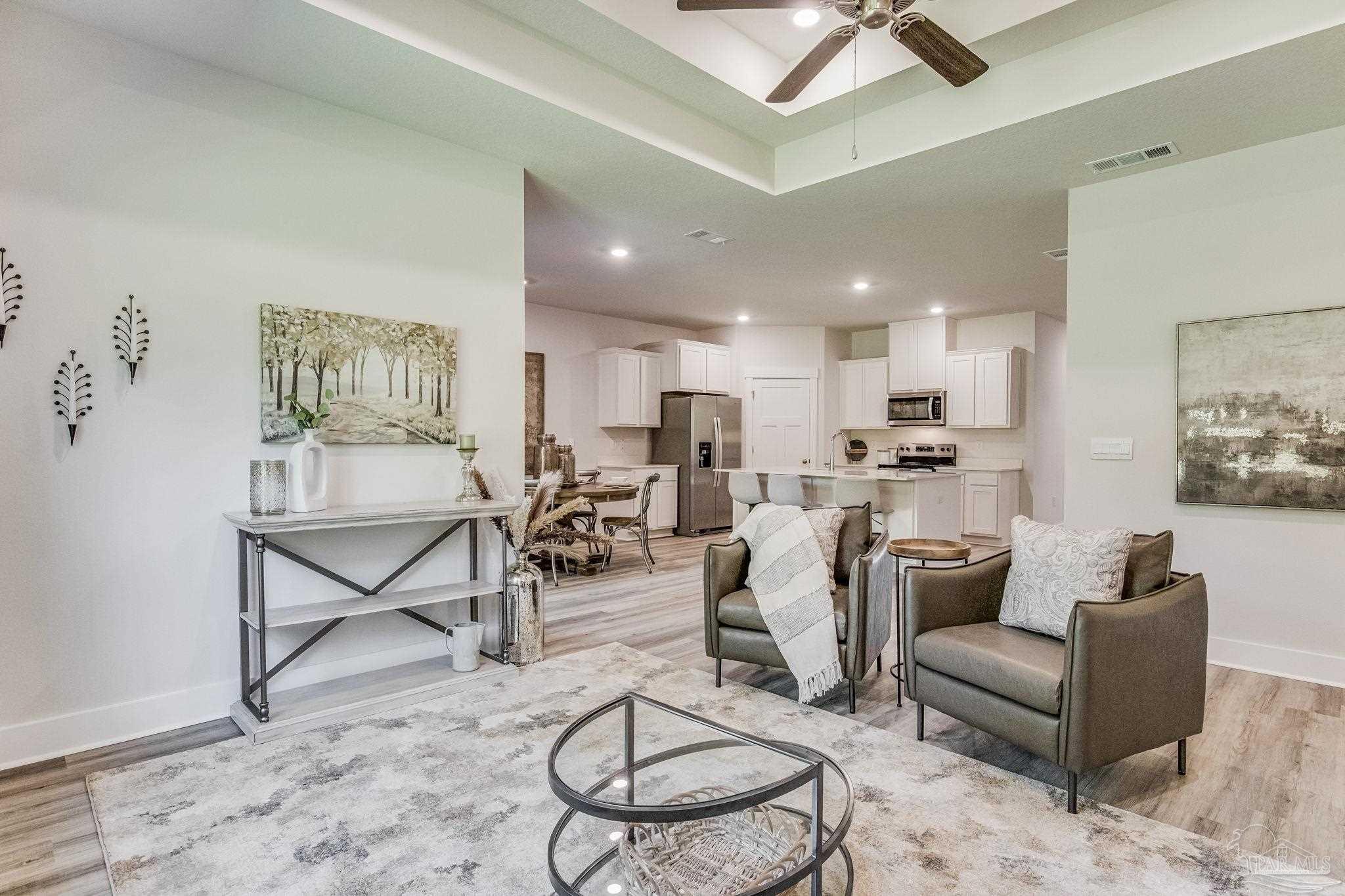 2490 Old Chemstrand Road Cantonment, FL 32533 - Photo 10 of 25 a living room with furniture a rug and white walls