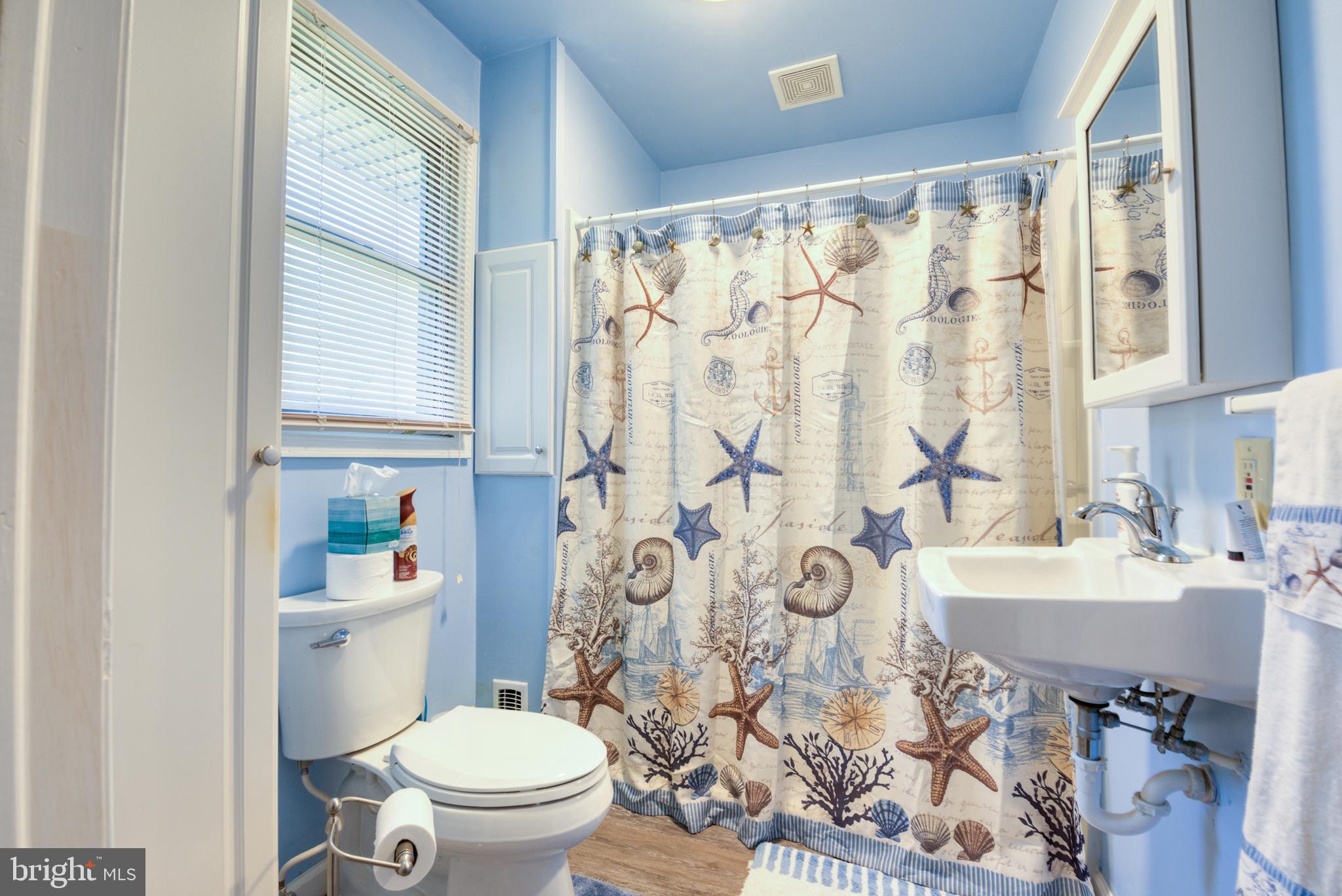 296 Berlin - Cross Keys Road Berlin, NJ 08009 - Photo 26 of 71 a bathroom with a sink a toilet and a mirror