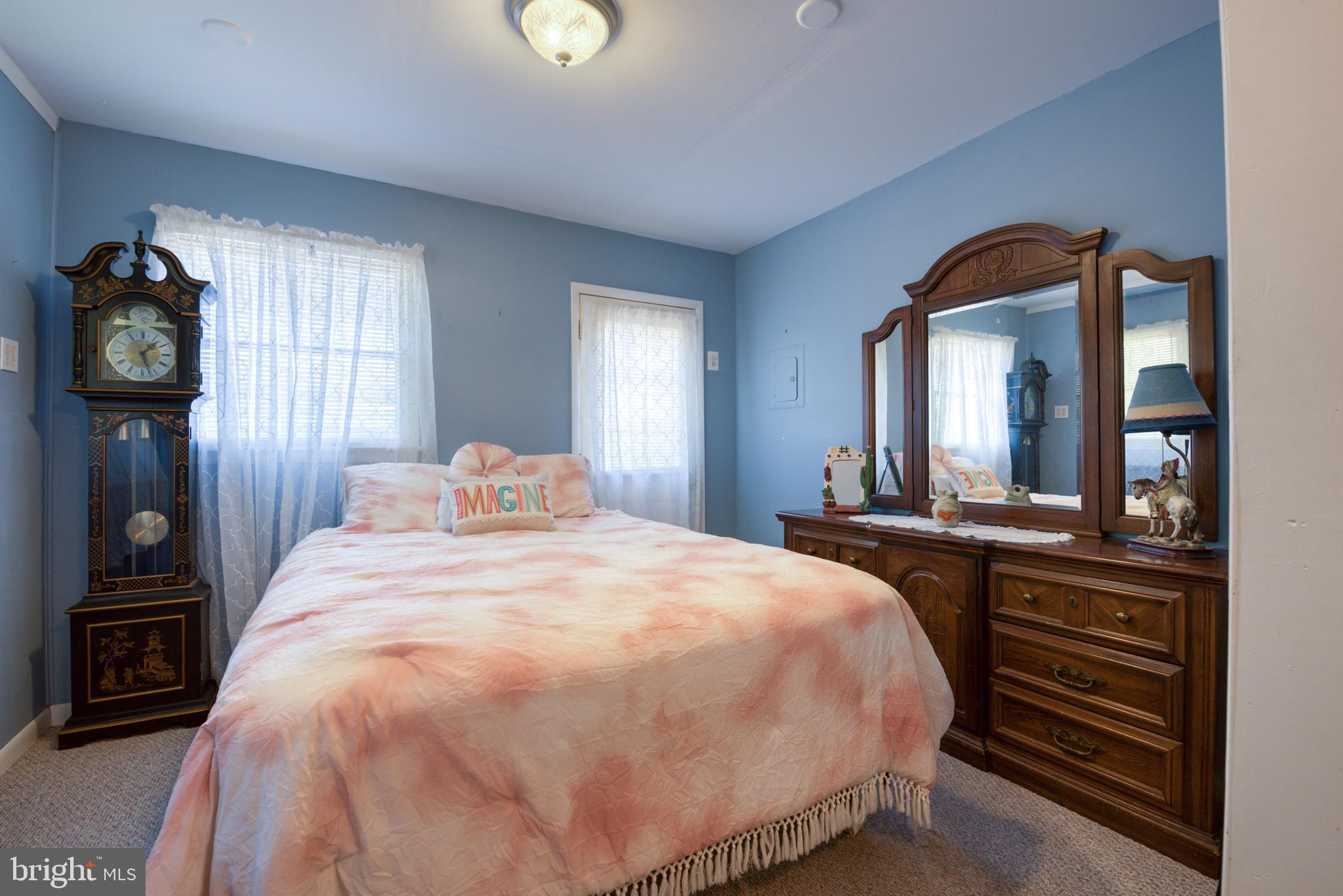 296 Berlin - Cross Keys Road Berlin, NJ 08009 - Photo 30 of 71 a spacious bedroom with a bed and a mirror on dresser