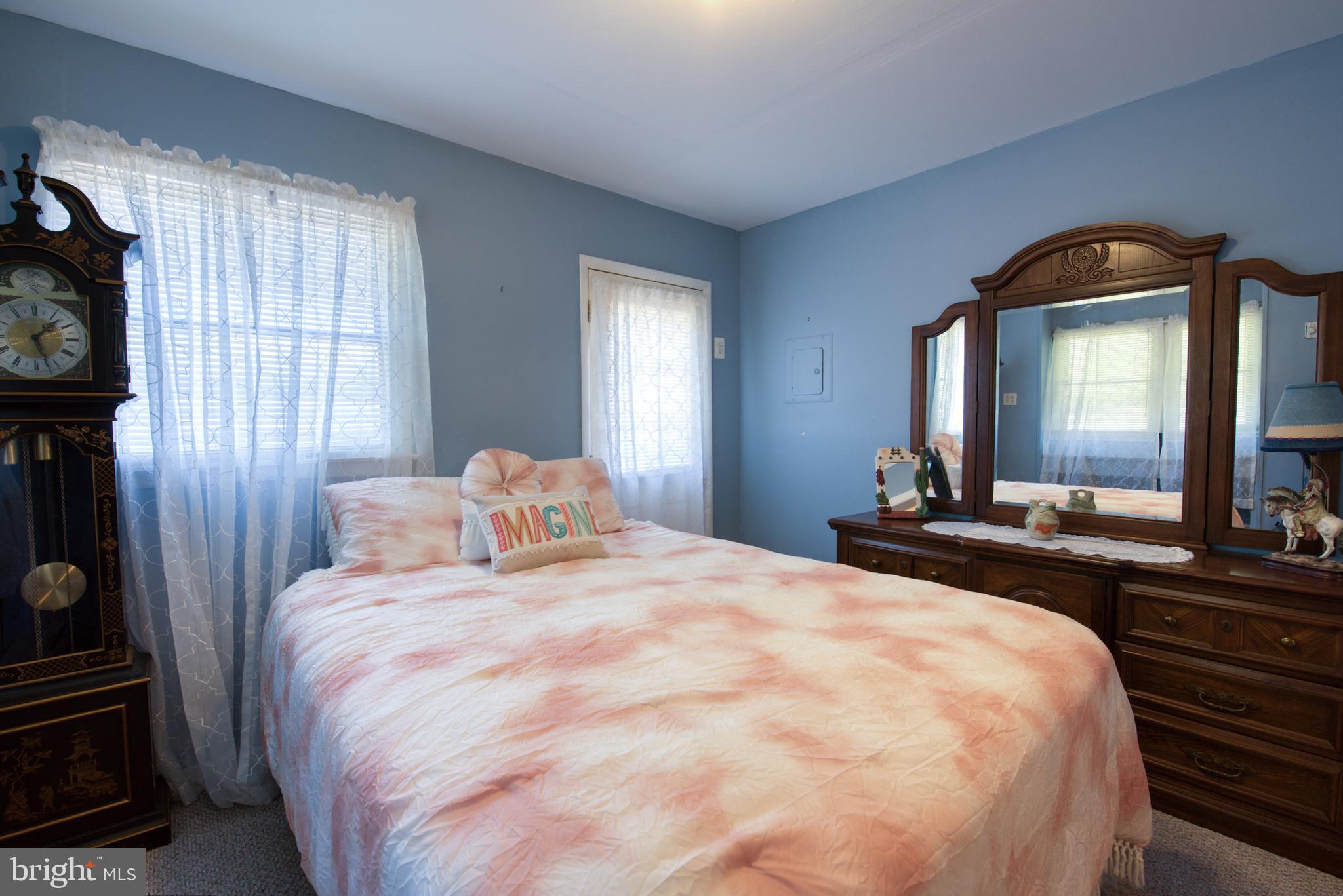 296 Berlin - Cross Keys Road Berlin, NJ 08009 - Photo 31 of 71 a bedroom with a bed and a large mirror on the dresser