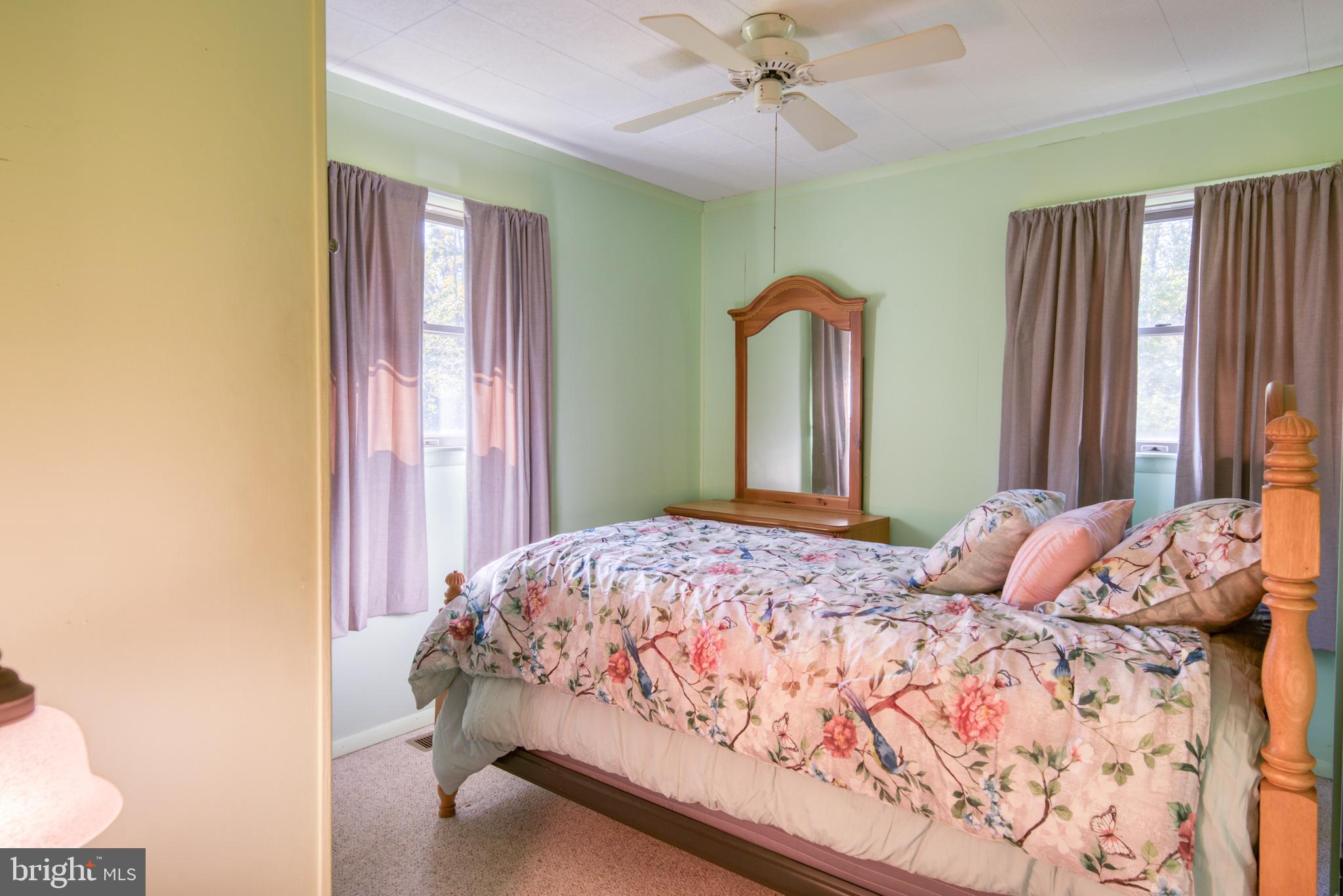 296 Berlin - Cross Keys Road Berlin, NJ 08009 - Photo 36 of 71 a bedroom with a bed and a chandelier
