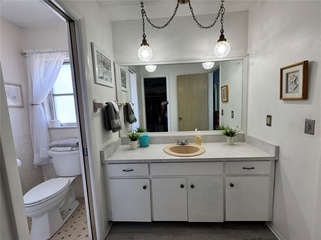 1048 Porpoise Road Venice, FL 34293 - Photo 17 of 26 a bathroom with a toilet sink and mirror