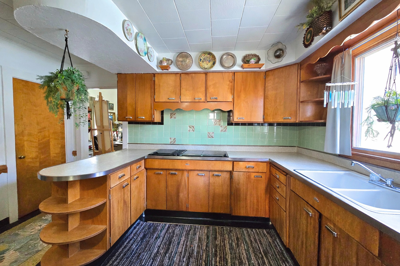 628 3rd Avenue South Clinton, IA 52732 - Photo 12 of 23 a kitchen with stainless steel appliances wooden cabinets a sink and a large window