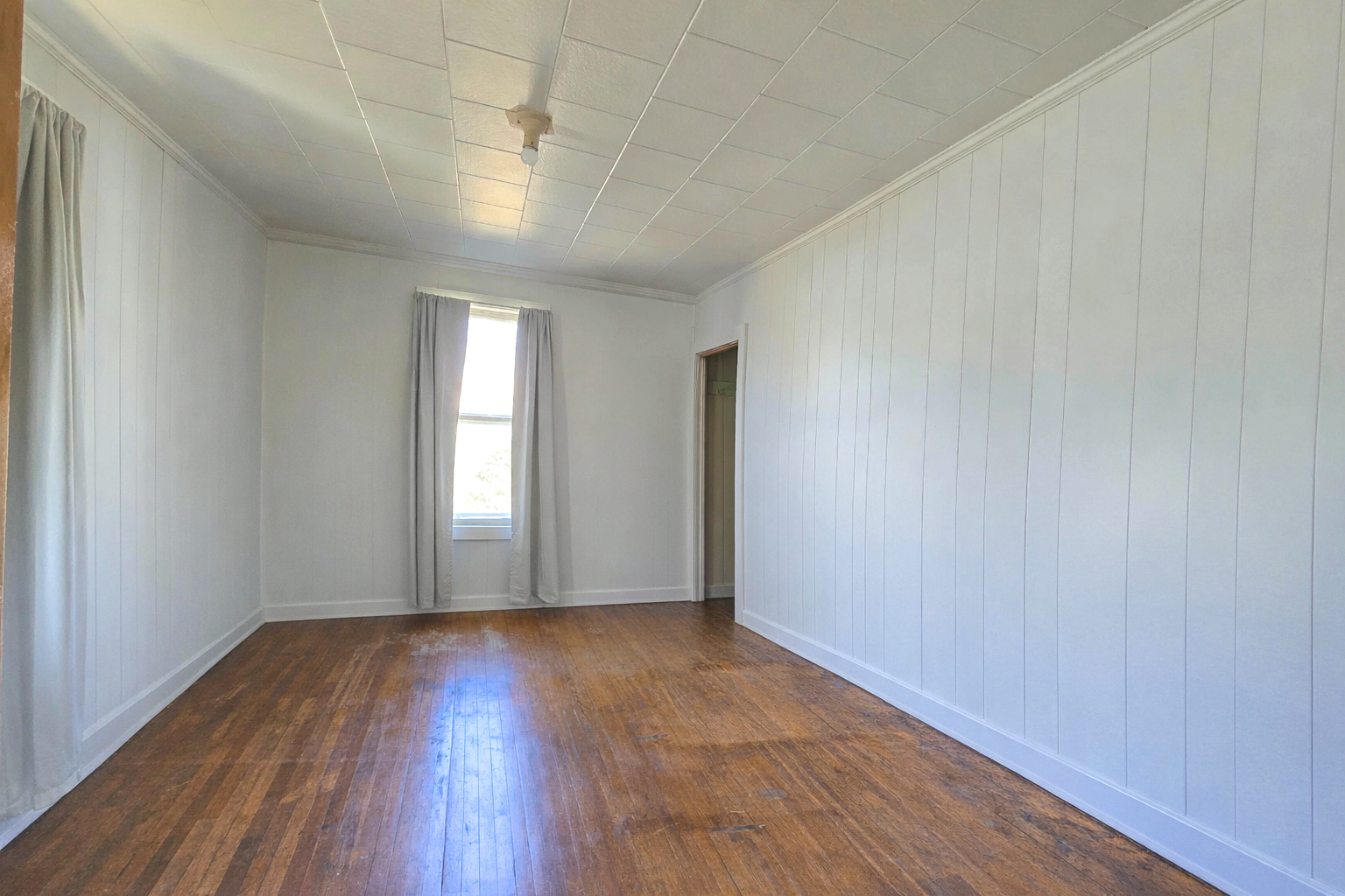 628 3rd Avenue South Clinton, IA 52732 - Photo 18 of 23 an empty room with wooden floor and windows