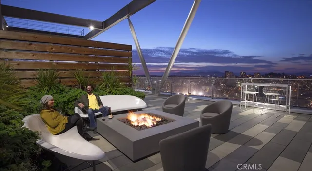 a view of a patio with couches and table and chairs and potted plants