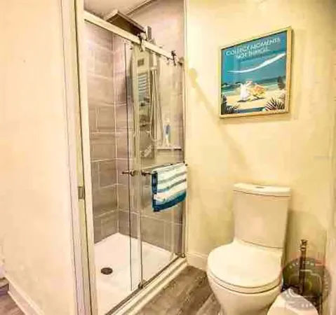 a bathroom with a toilet and a shower
