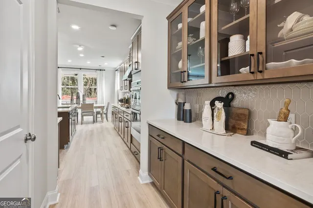 a kitchen with cabinets and wooden floor