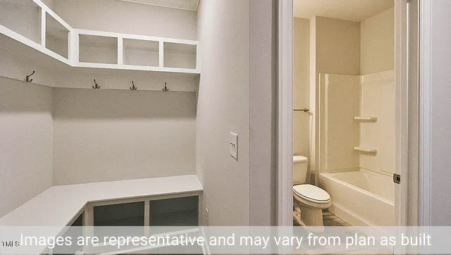 a bathroom with a shower a toilet and a sink