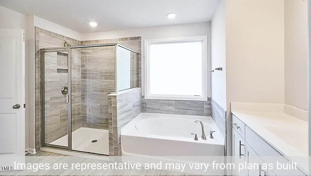 a bathroom with a shower a bathtub and a shower