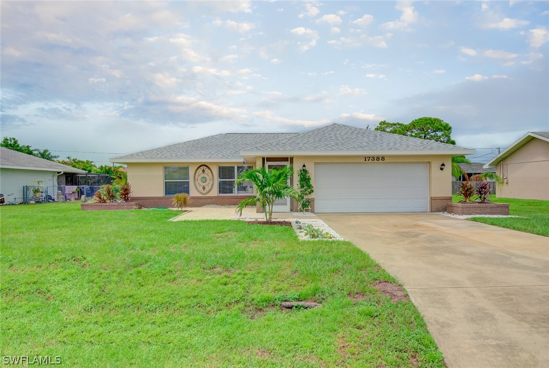 17388 Ingram Road Fort Myers, FL 33967 - Photo 1 of 18 a front view of a house with a yard and garage
