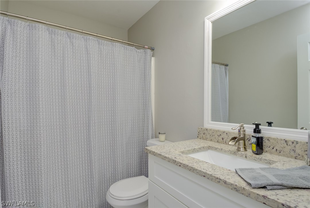 17388 Ingram Road Fort Myers, FL 33967 - Photo 13 of 18 a bathroom with a granite countertop sink and a mirror