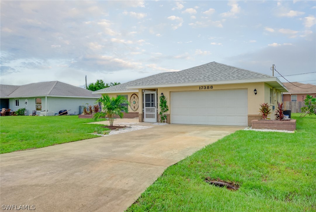 17388 Ingram Road Fort Myers, FL 33967 - Photo 18 of 18 a front view of a house with a yard and garage