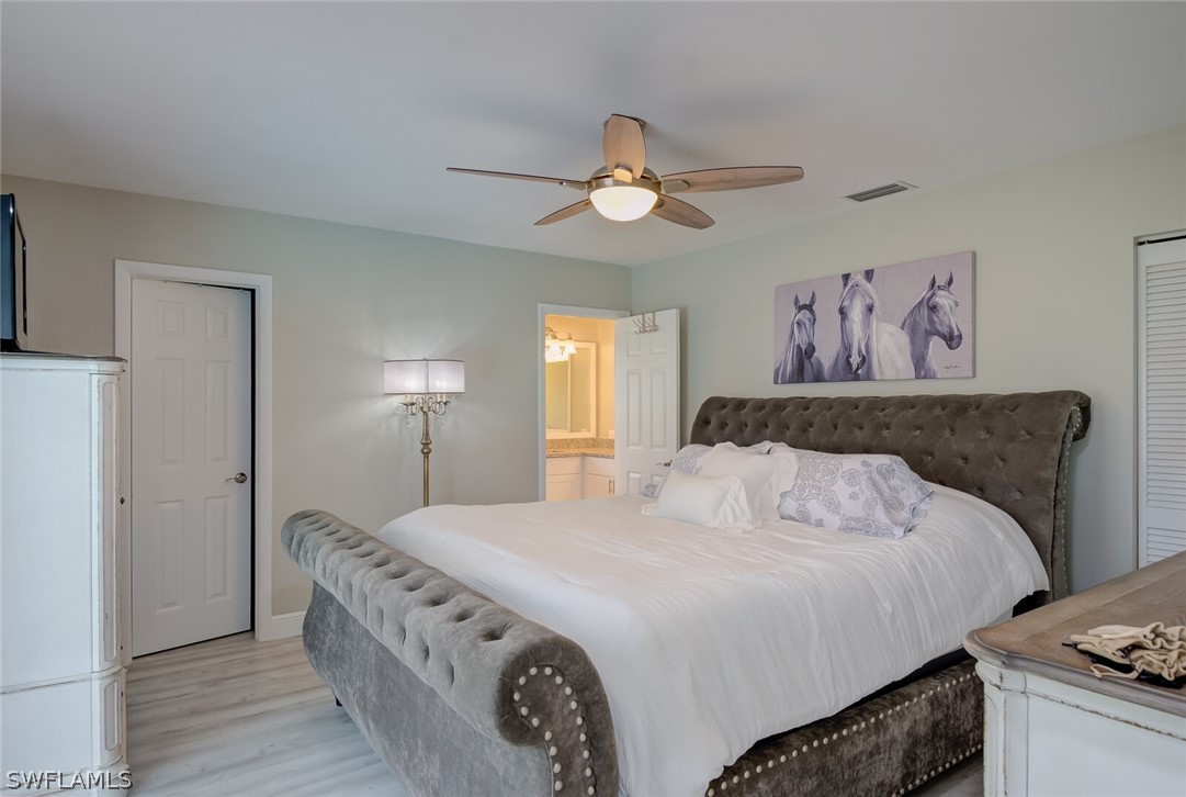 17388 Ingram Road Fort Myers, FL 33967 - Photo 8 of 18 a bedroom with a bed and a chandelier